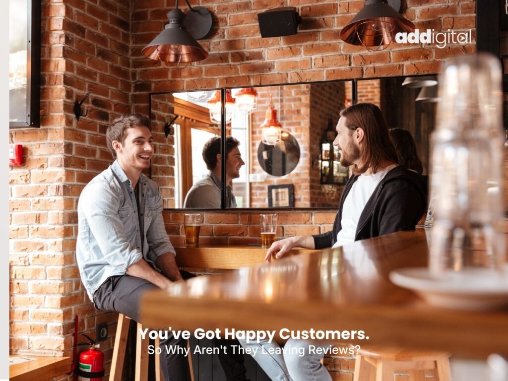 Two customers chatting inside a local Auckland café, illustrating how customer experiences, reviews and online reputation influence trust and business growth for small businesses.