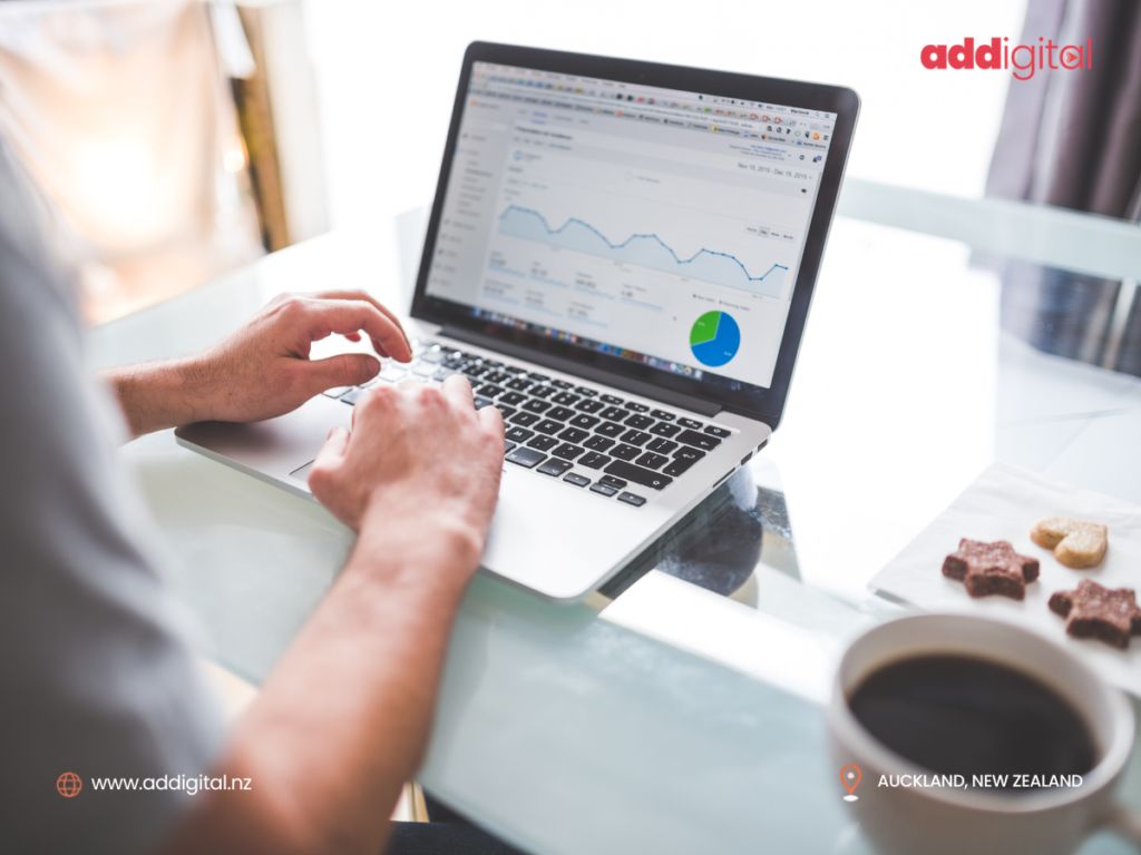 Small business owner reviewing Google Ads campaign performance on a laptop while planning business growth in Auckland, New Zealand.