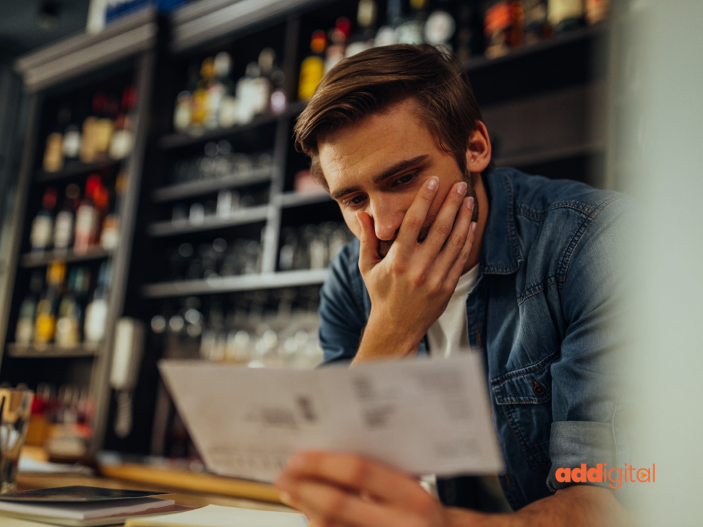 Small business owner looking concerned while reviewing business information, representing the frustration of referrals not turning into customer enquiries.
